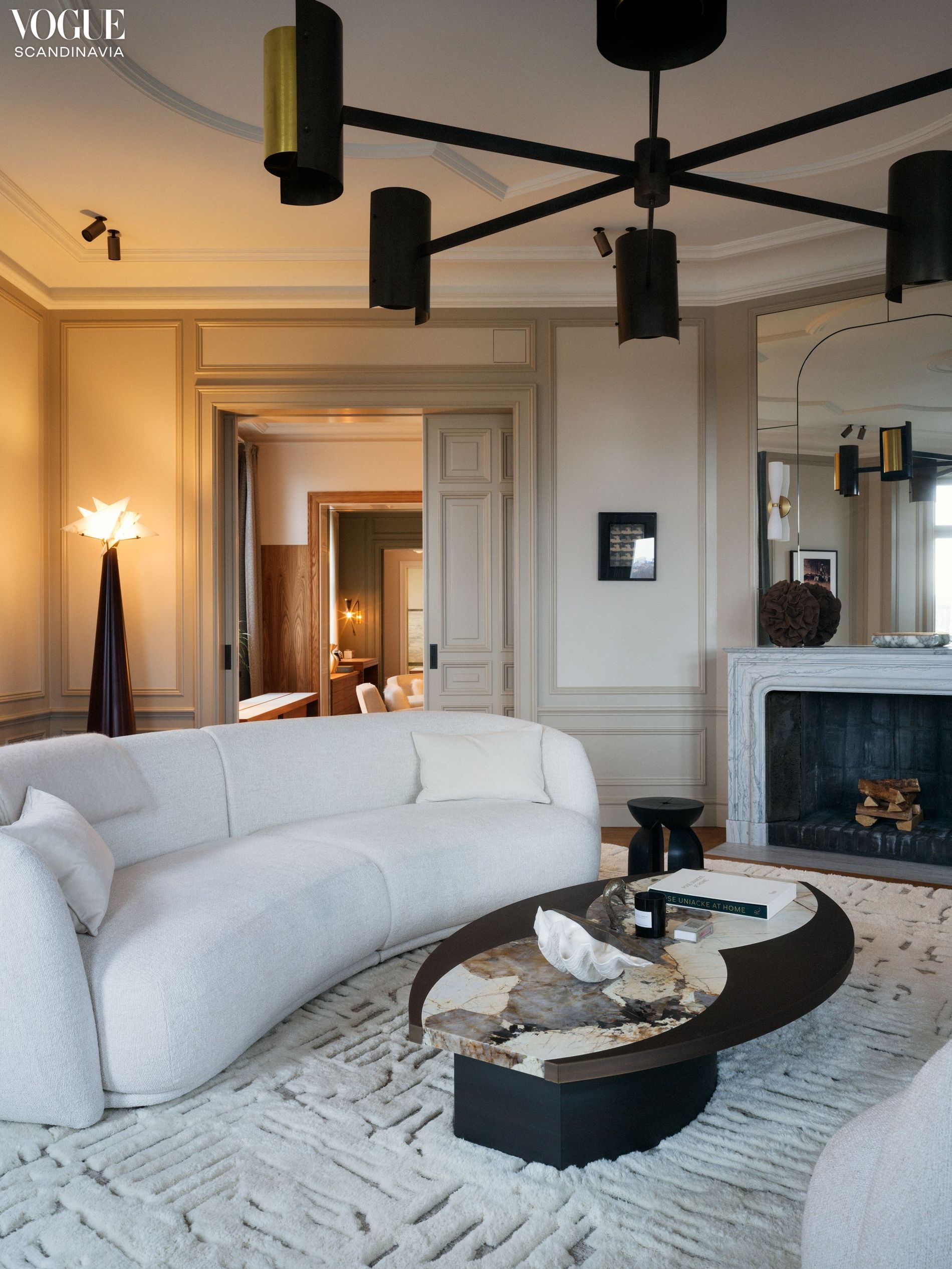 A neutral-coloured living room with white sofas
