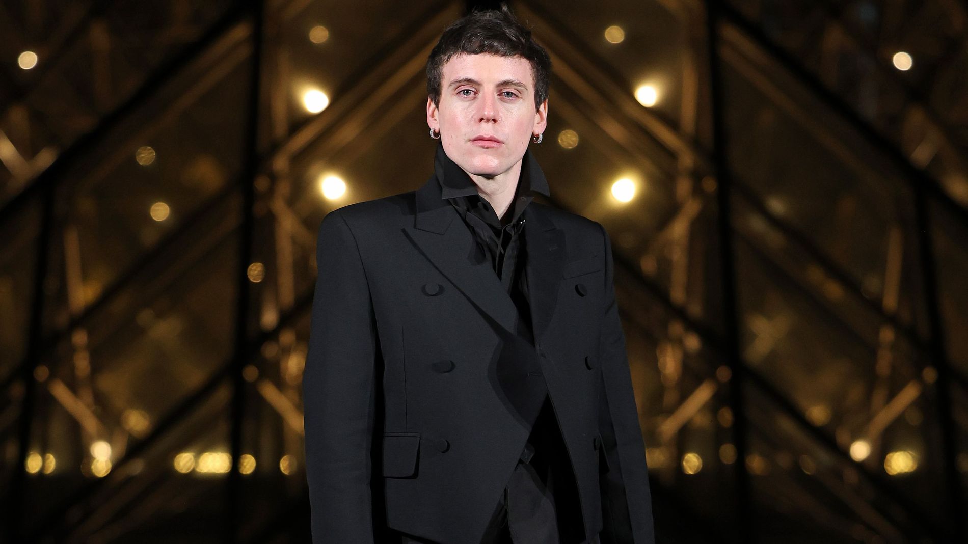 Sean McGirr former creative director of Alexander McQueen  stands outside of the Louvre, during a dinner in Paris