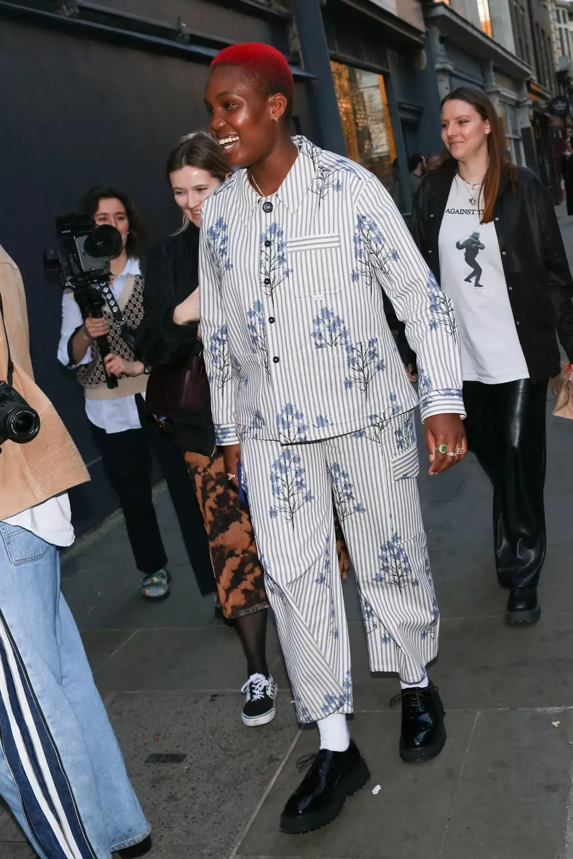 London fashion week guest wears striped suit with floral details