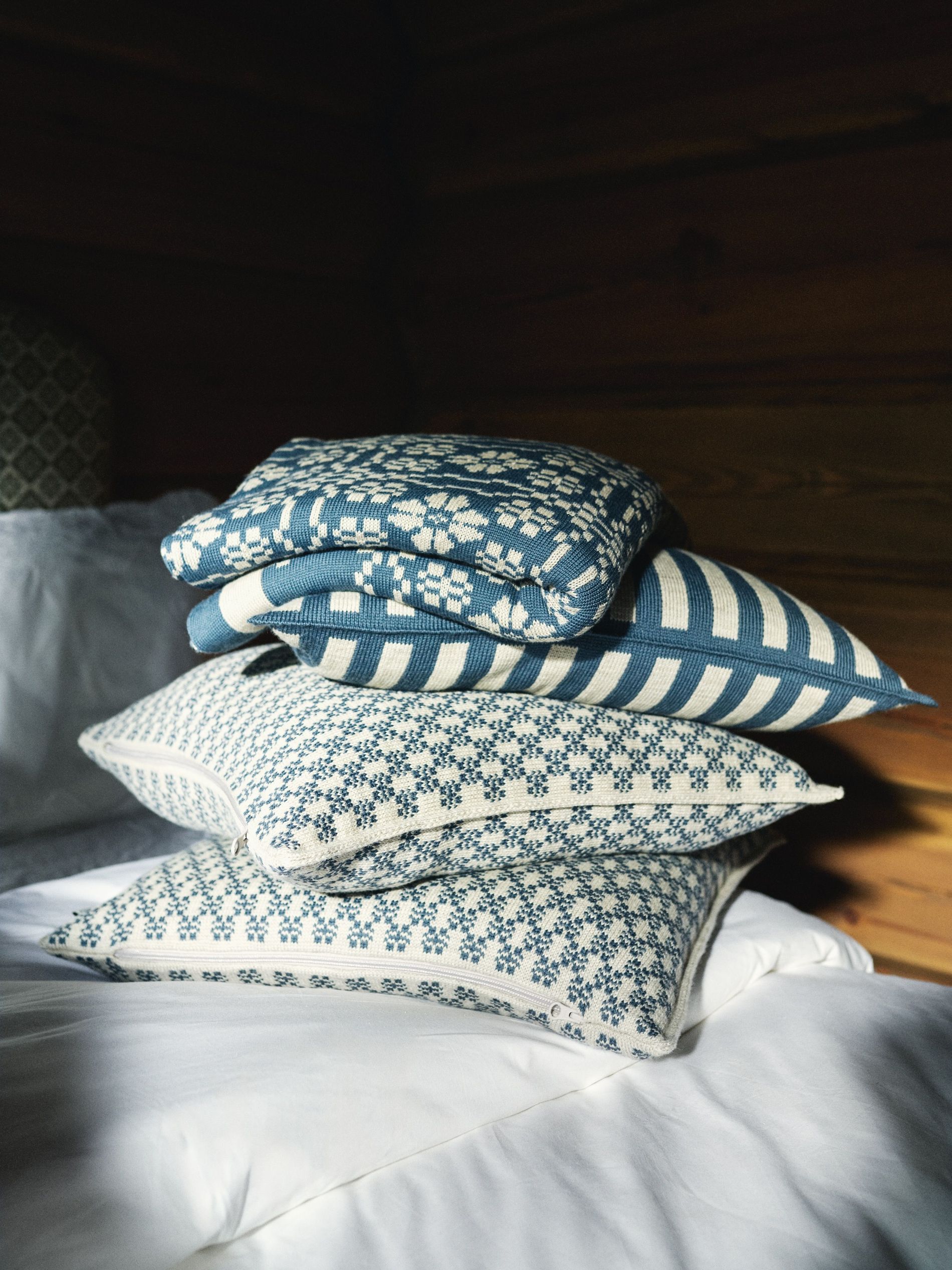 Pillows from Dale Of Norway collaboration with Pernille Døsvik in a pile on the sofa