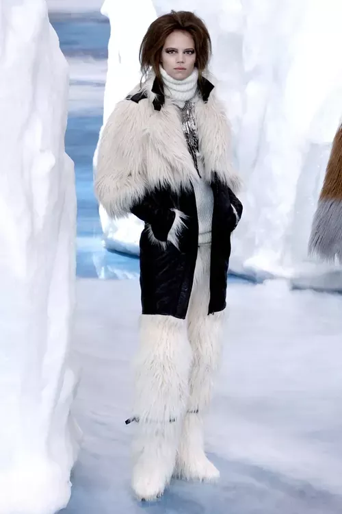 Model wearing fur boots and a matching coat stands with Chanel's ice berg imported from Scandinavia 