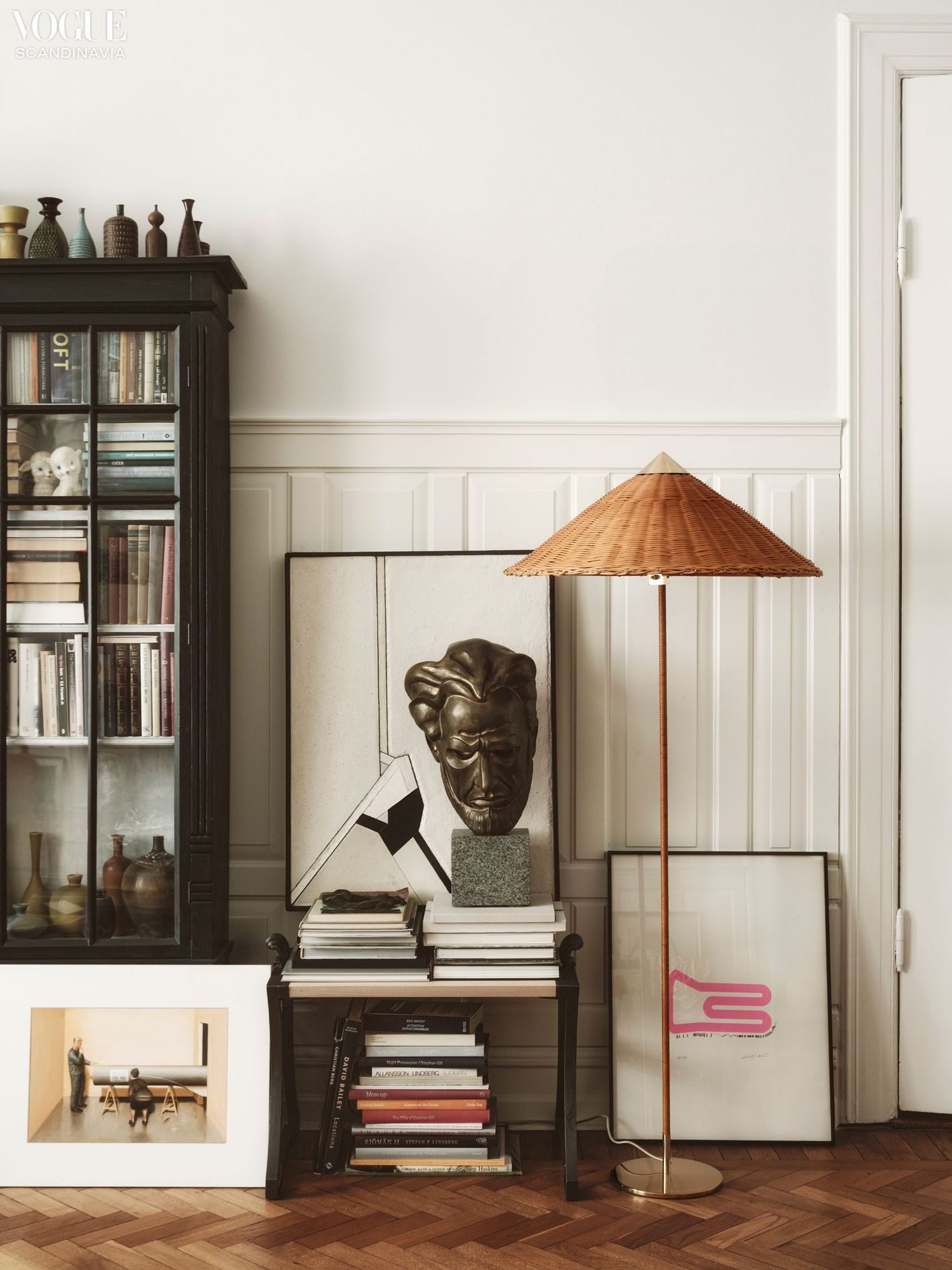 Rattan floor lamp in an art-filled room