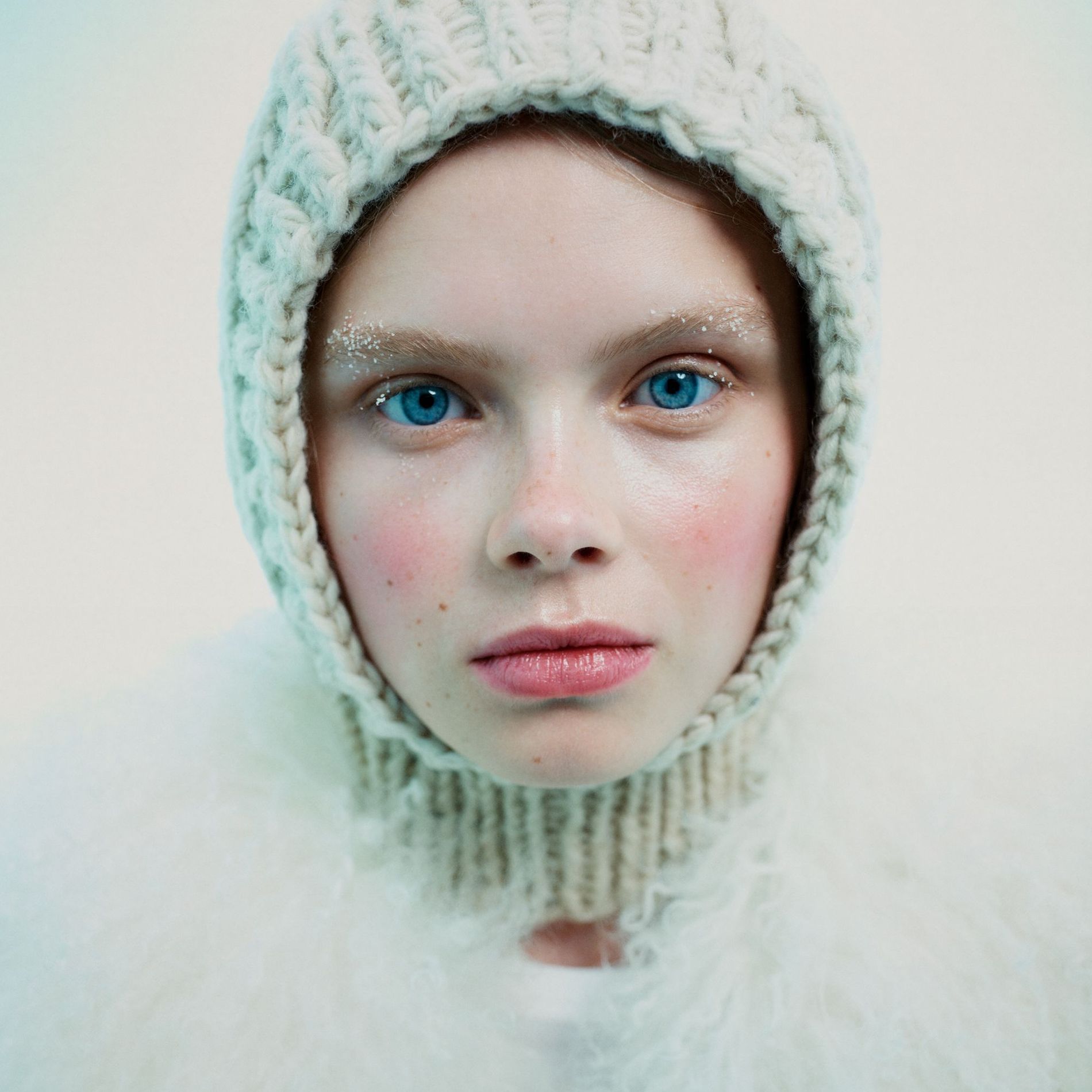 Model poses with red cheeks, snow-brushed brows and a balaclava