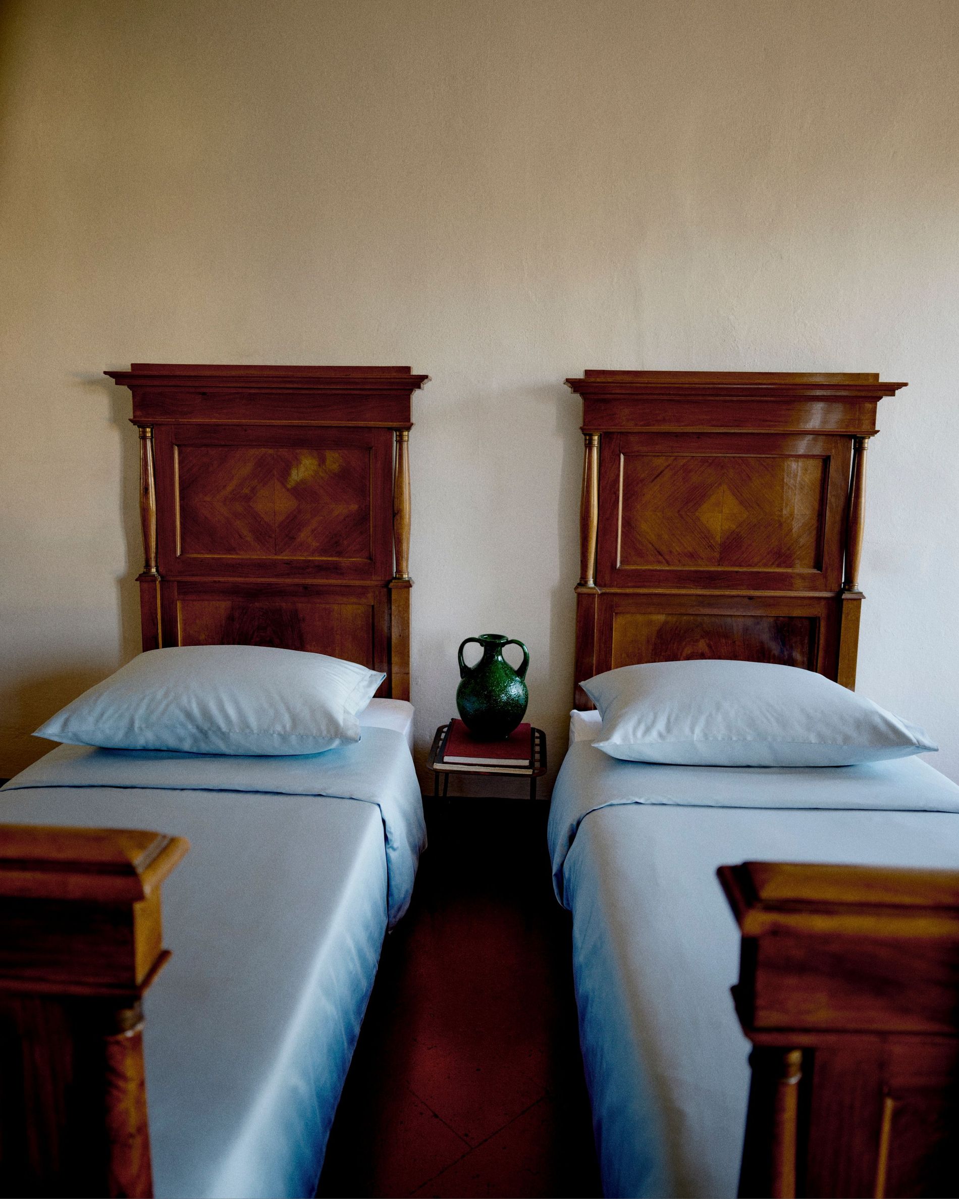 Two beds covered in blue sheets as part of the campaign photography shot in Lombardy 