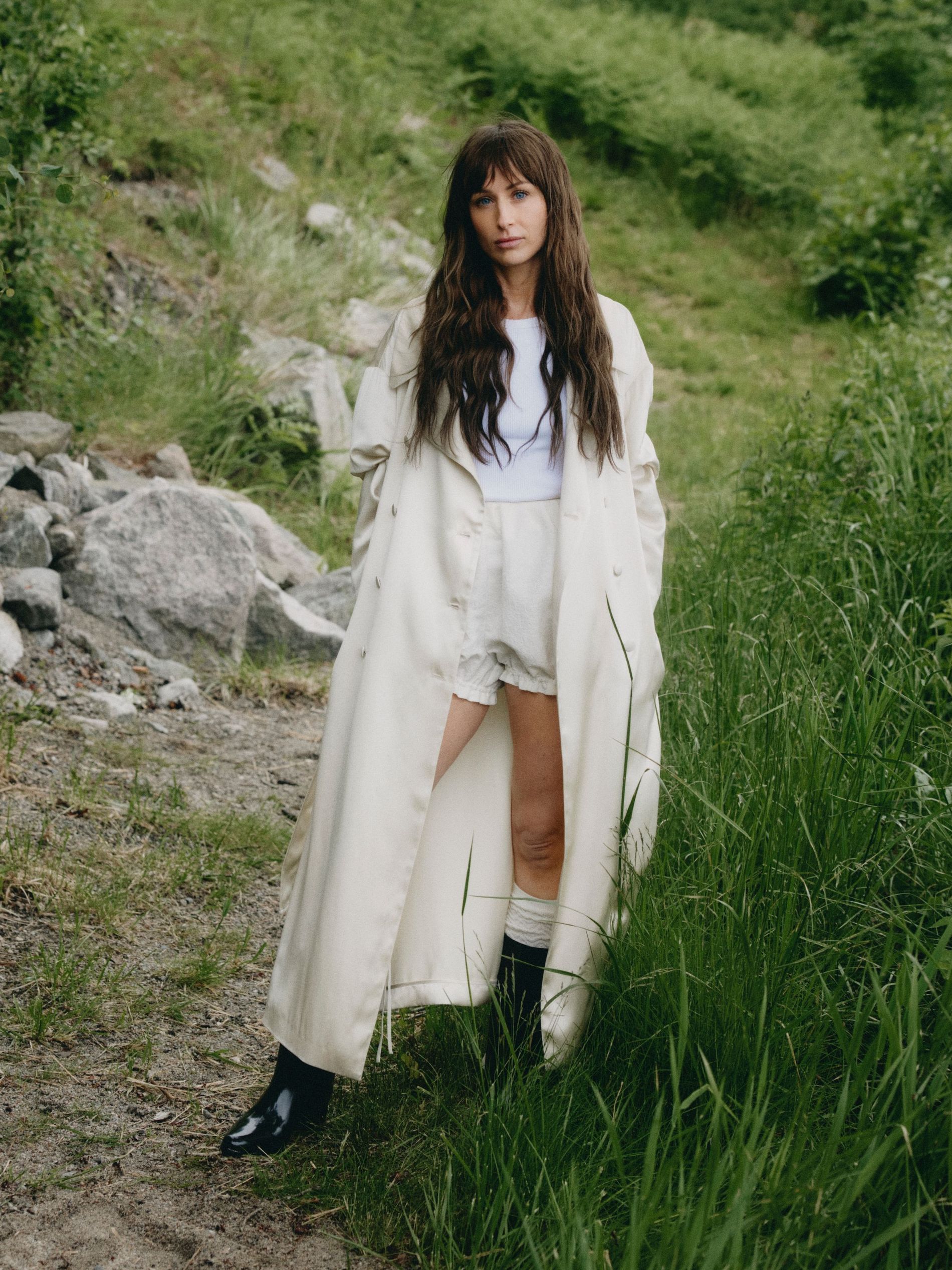 Model wearing cotton tank top, silk coat, bloomers, wool leg warmers and polished calf leather boots