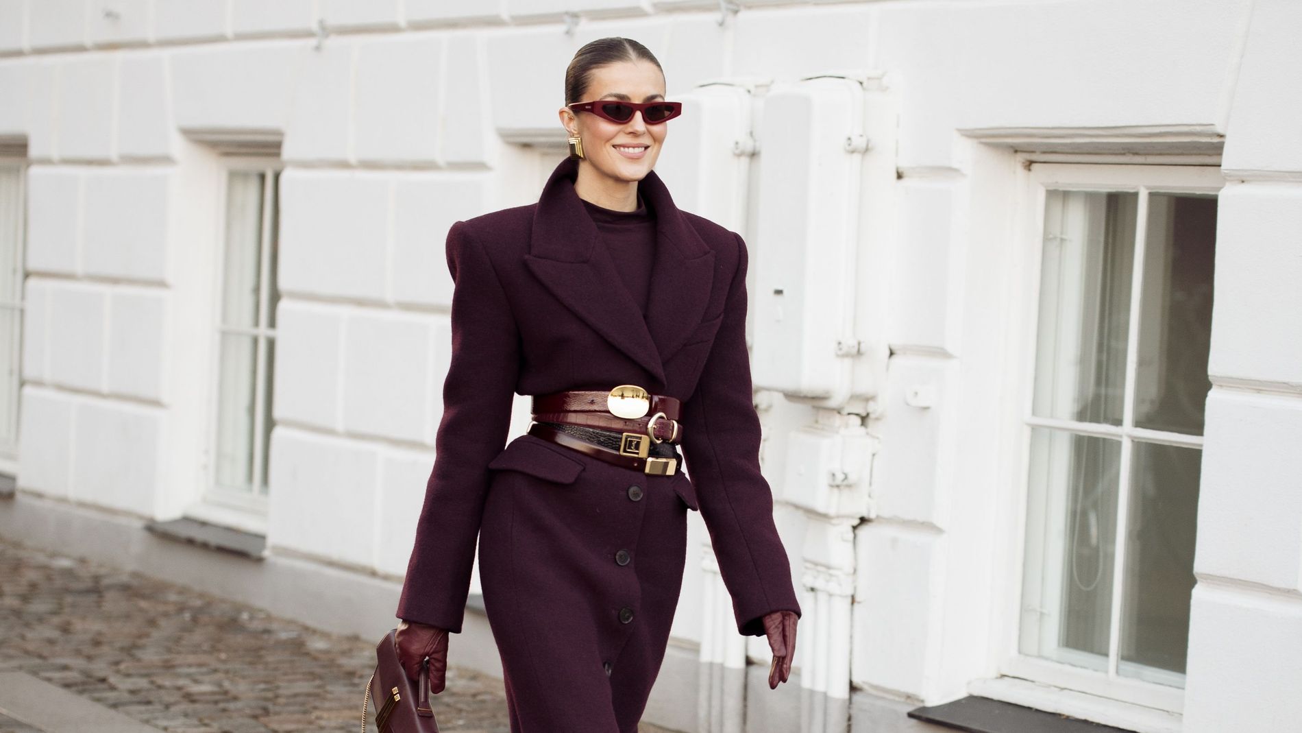 Nina Sandbech wearing a full monochrome look in burgundy with stacked belts 