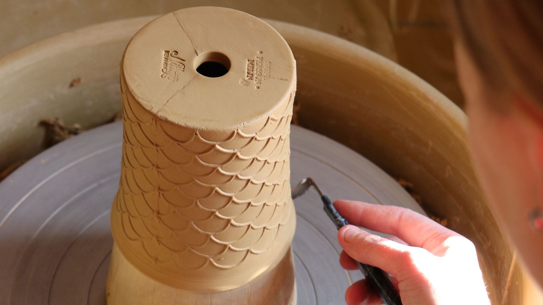 A woman crafting a vase at the Nittsjö Keramik factory