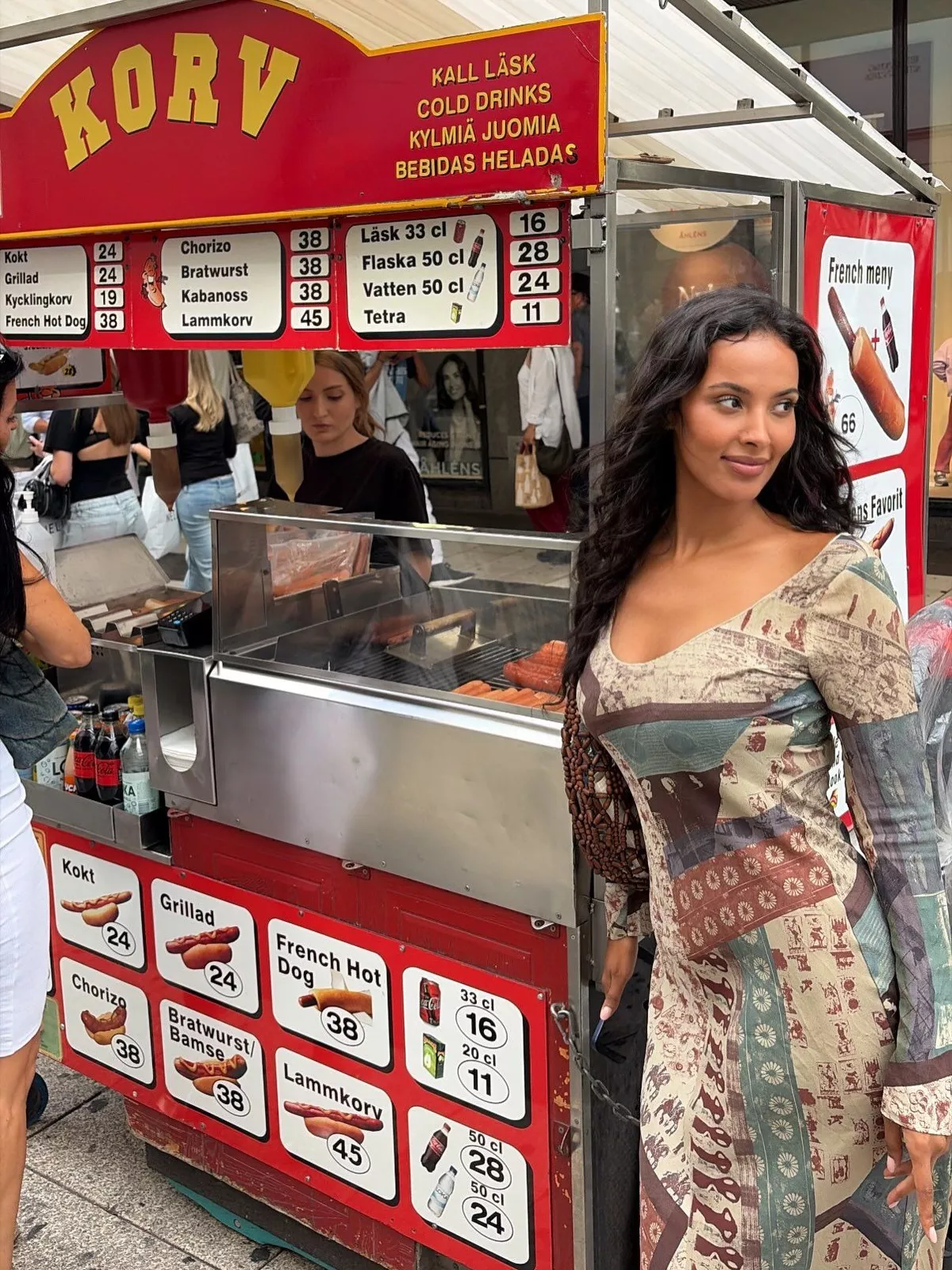 Maya Jama stands by a Korv stand in Stockholm