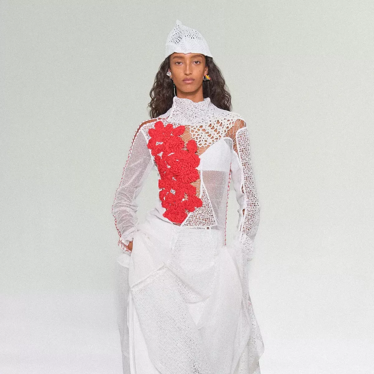 Mona Tougaard walks Bottega Veneta in an all white look with red floral accent