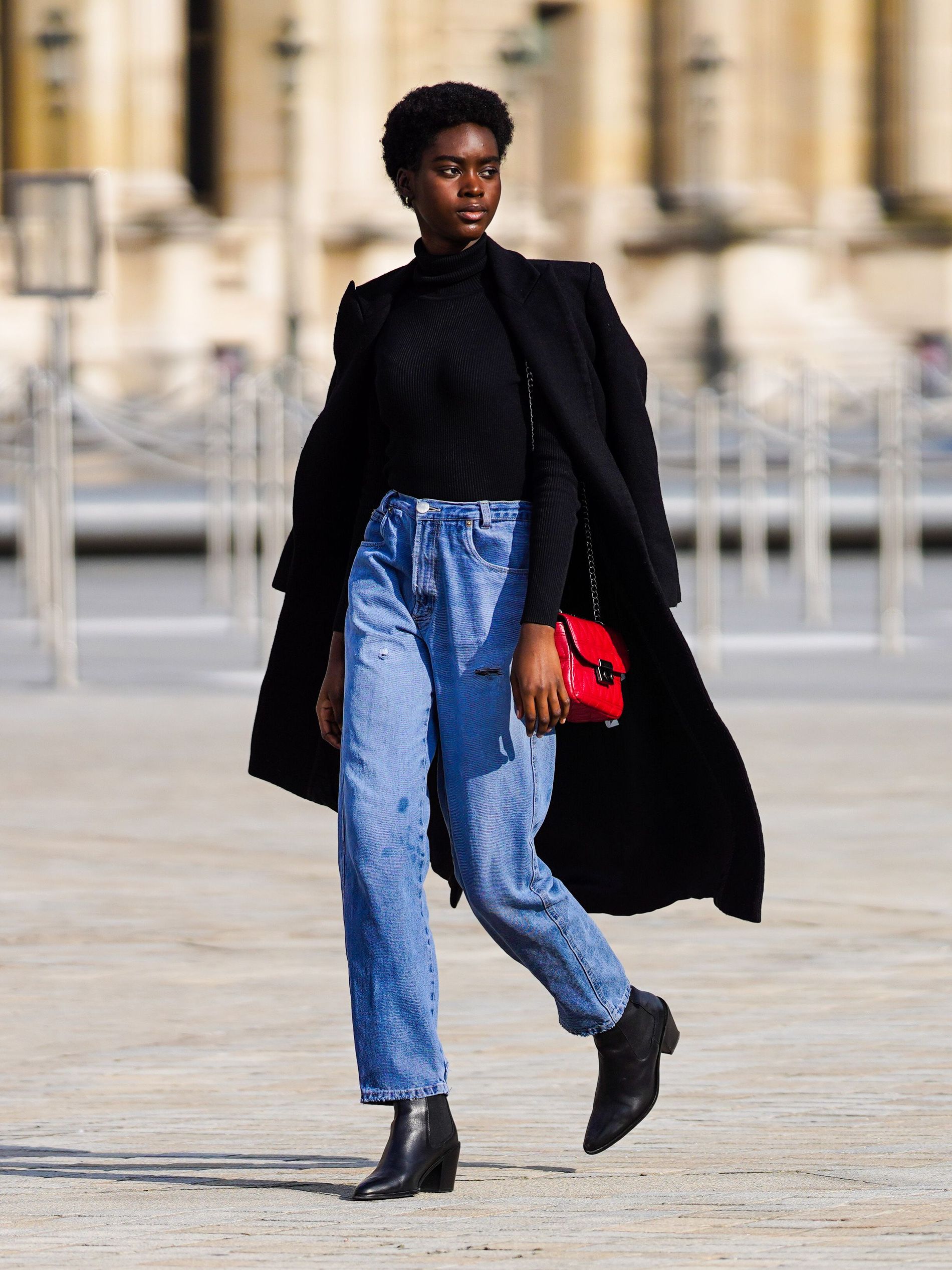 The classic, black coat paired with a colourful bag