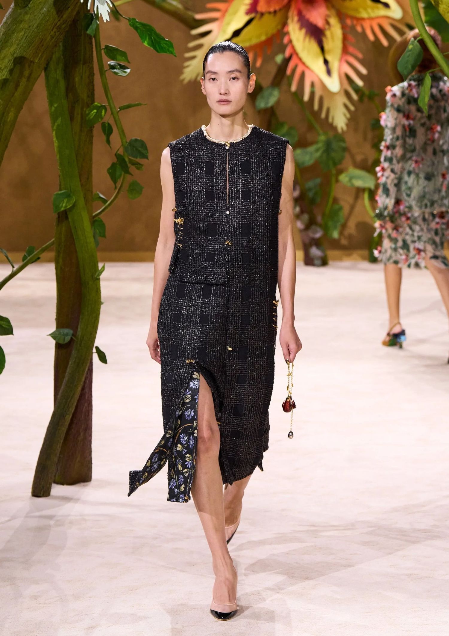 Long short-sleeved black textured dress with a slit