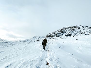 A person climbing a snowy mountain