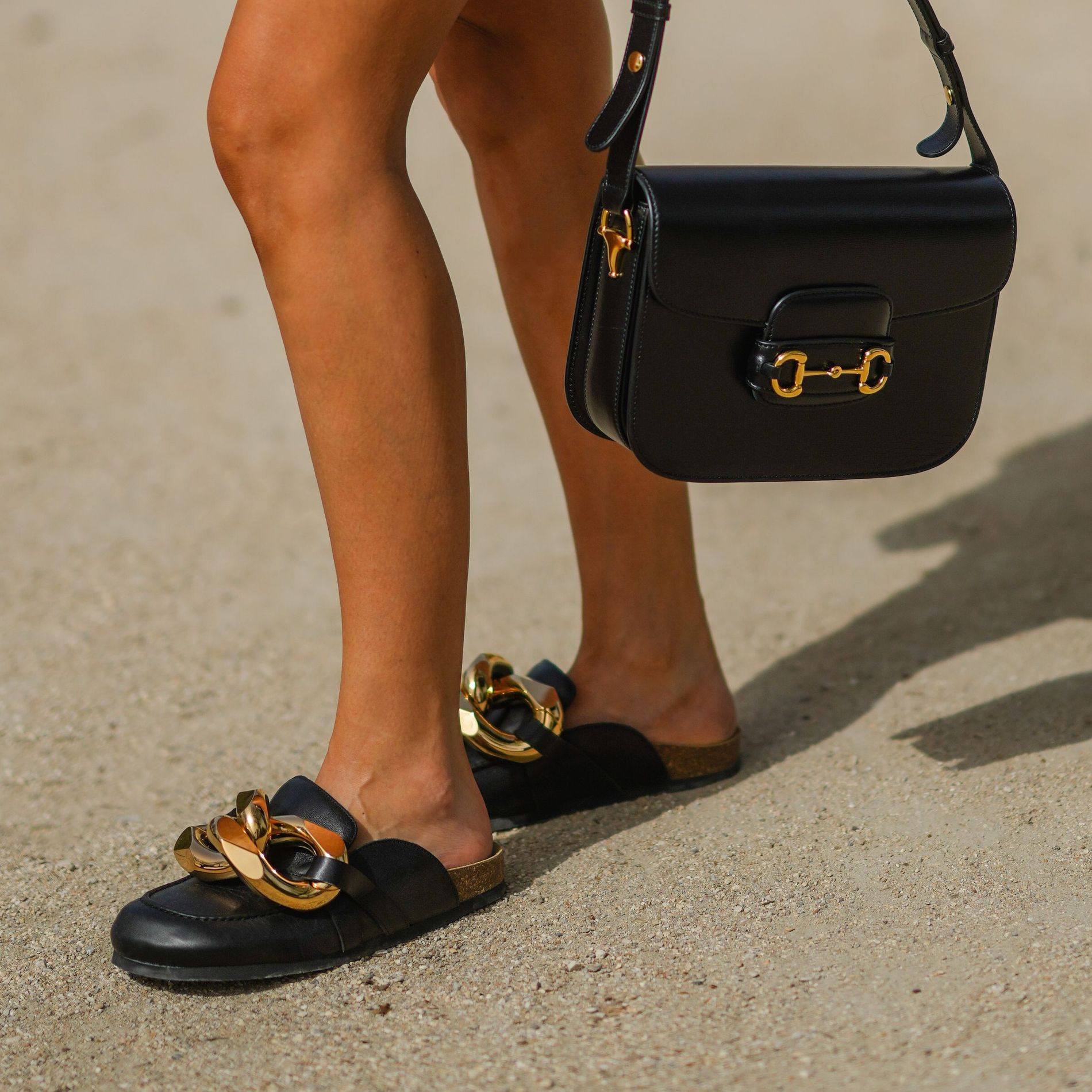 black leather Gucci bag, black leather sandals / shoes with golden inserts from JW Anderson