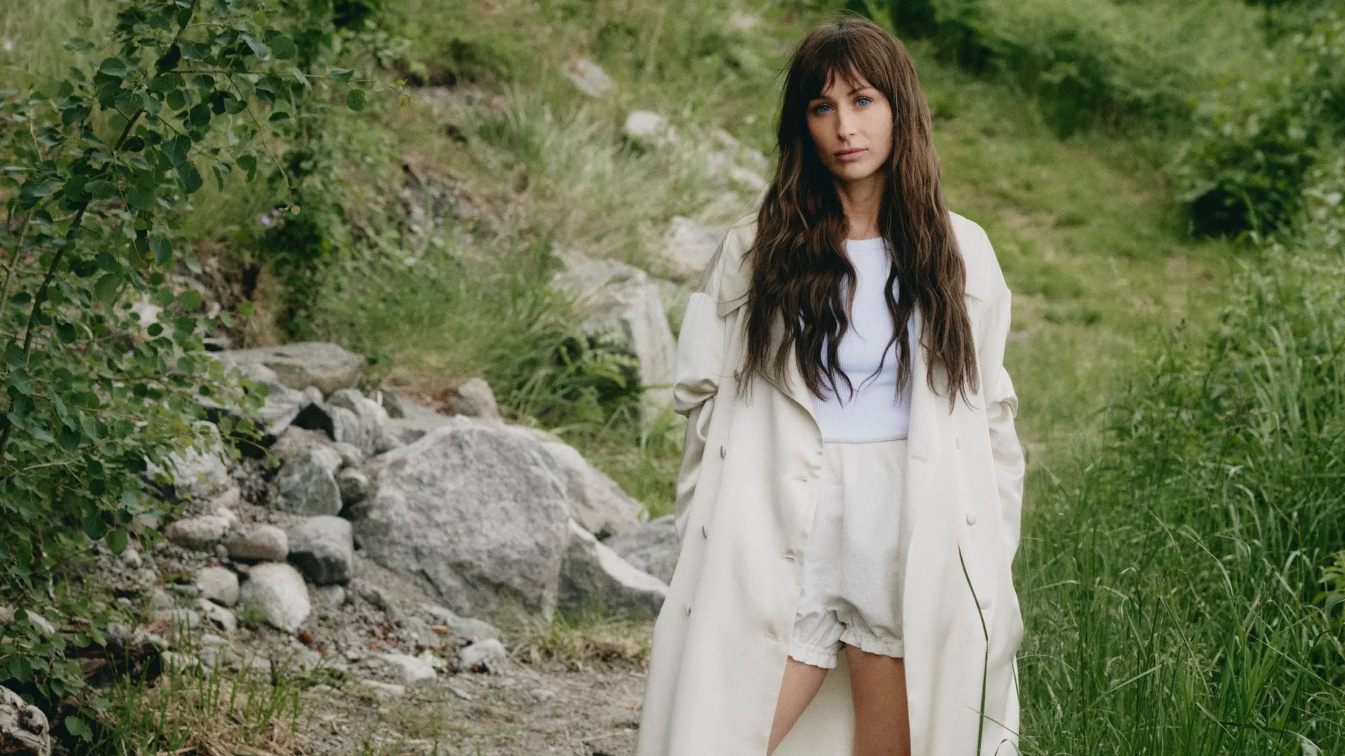 Model wearing cotton tank top, silk coat, bloomers, wool leg warmers and polished calf leather boots