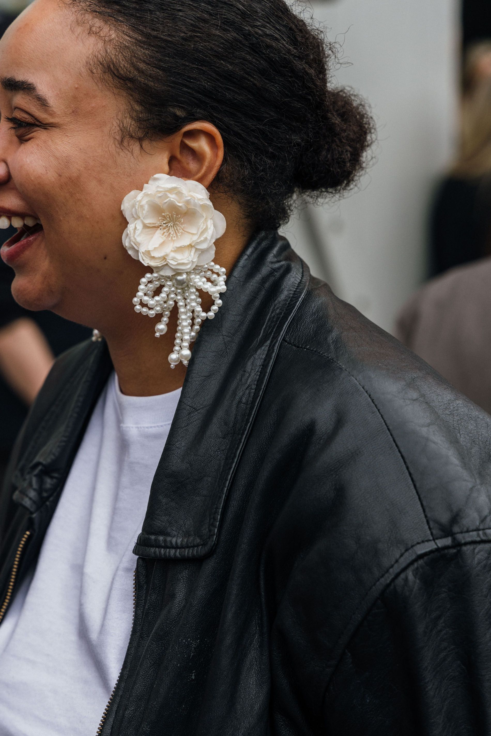 Guest wears a pair of rose statement earrings to Copenhagen Fashion Week SS24