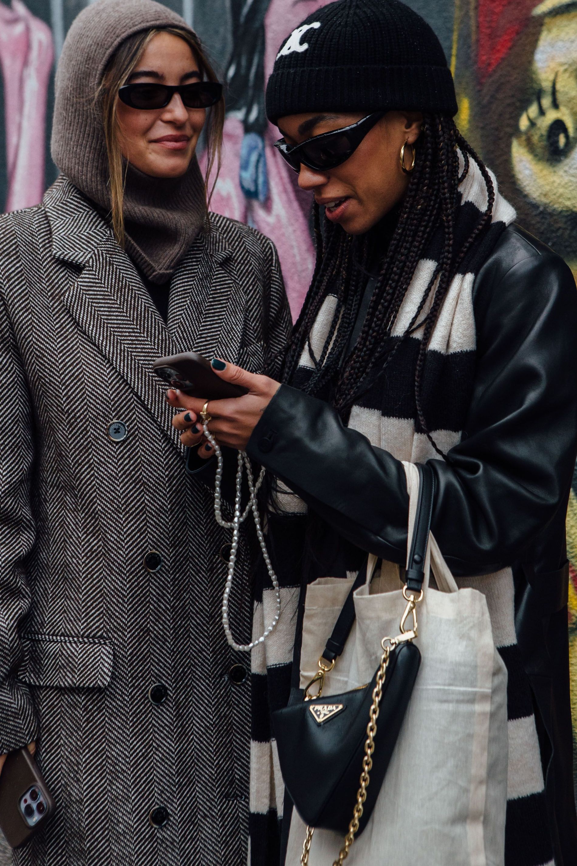 A guest wears a taupe balaclava with matching herringbone coat and black cat-eye sunglasses